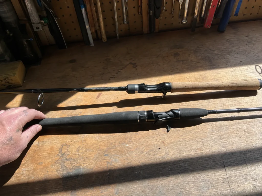 A spinning rod and a casting rod laid side by side showing reel seat orientation, guides and handle materials