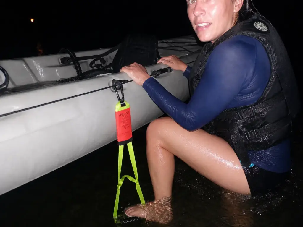 Rope ladder rescue step clipped to a kayak deck line giving a foothold for reentry at dusk