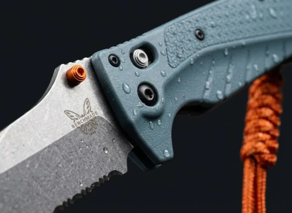 Extreme macro close-up of the Benchmade Fishcrafter blade and handle, showing the MagnaCut steel texture and premium build quality.