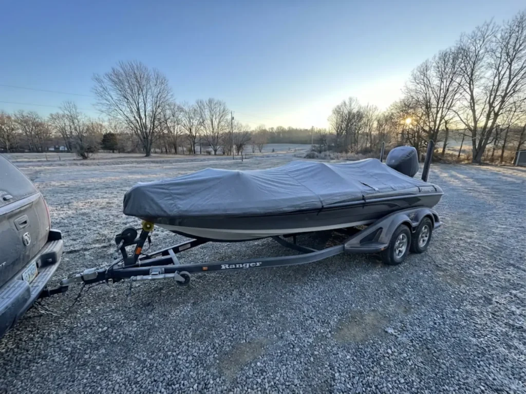 Bass boat in outdoor winter storage with frost showing freeze risk conditions