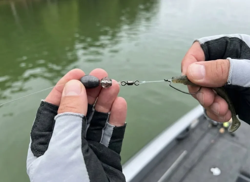 Close-up Carolina Rig components showing tungsten weight, glass bead, and swivel assembly