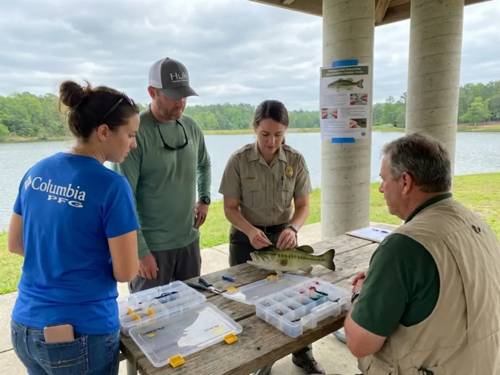 Anglers attending catch and release workshop learning proper fish handling and hook removal techniques