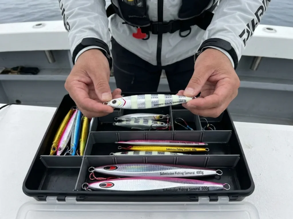 Angler selecting Shimano Shimmerfall and Submission Fishing jigs for deep water vertical jigging