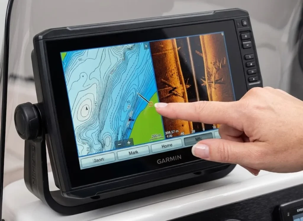 Macro close-up of a Garmin fish finder screen displaying bathymetric contour maps, with a finger interacting with the touchscreen interface.