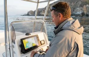 How to Fish Legally in Marine Protected Areas Angler checking GPS chartplotter for marine protected area boundaries on California coast