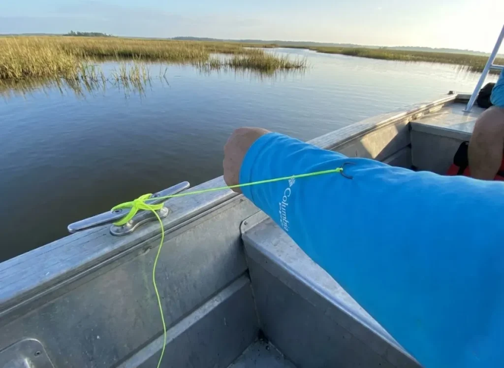 Using a boat cleat as an anchor point for solo fish hook removal with braided line.