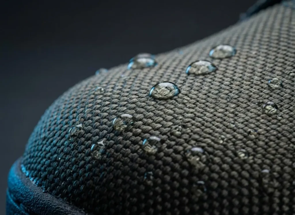 Macro photography shot of the woven aramid fiber texture on a stingray-proof wading boot, highlighting the puncture-resistant material.