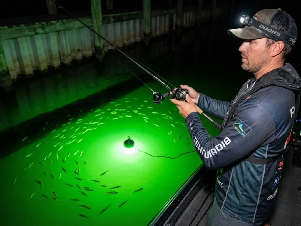 Night bass fishing with buzzbait near submersible green fishing light shadow line
