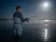 Full Moon Lockjaw Is Real—Here’s How to Beat It Angler casting under full moon in tidal estuary demonstrating night fishing tactics