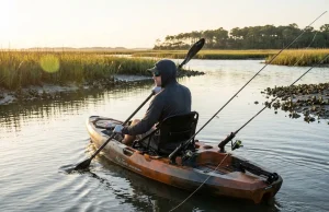Best Kayak Rod Holders Flush Mount — What We’d Buy Kayak angler trolling with flush mount rod holders installed on fishing kayak deck