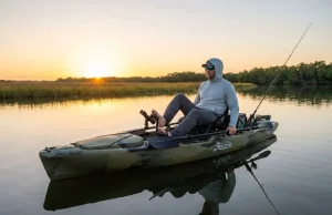 What Nobody Mentions About Pedal Drive Kayak Fishing Angler pedaling Hobie fishing kayak across shallow saltwater flat at dawn