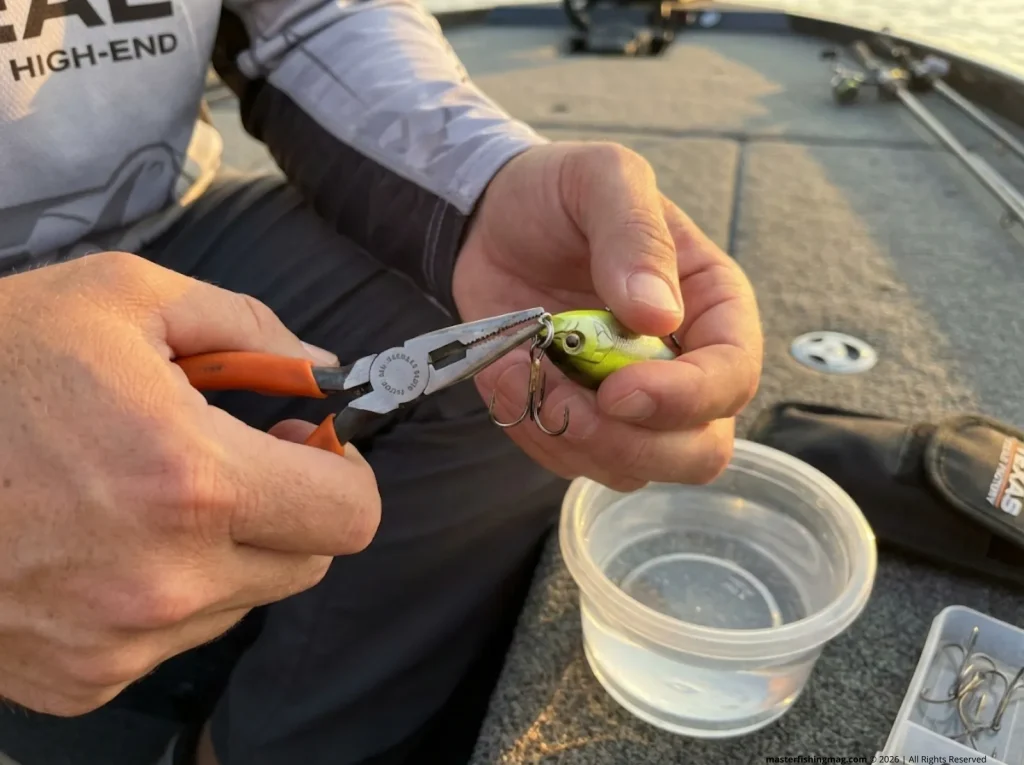 Split-ring pliers threading Owner ST-36 treble onto Lucky Craft crankbait belly eye