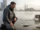 Why Fish Behave Strangely in Thermally Polluted Water Angler observing disoriented fish near power plant thermal discharge plume with steam rising