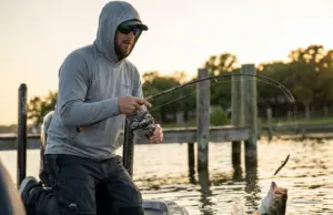 Wacky Rig Mastery After Testing 6+ Months Angler fighting largemouth bass on wacky rigged Senko at golden hour Texas lake