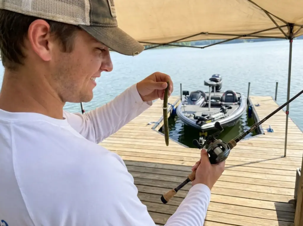 Angler examining durable wacky rigged Senko with O-ring after multiple bass catches