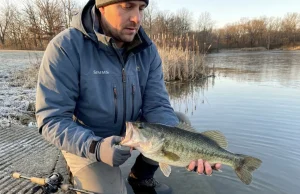 Cold Water Bass Quit Biting Until I Changed This Angler releasing largemouth bass into cold winter lake from bank — winter bank fishing cold water tactics