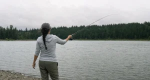 Rod Blank Feels Soft? Spot the Crack Before It Snaps Angler checking a graphite rod blank for a crack at dawn before fishing, running a thumb along the blank