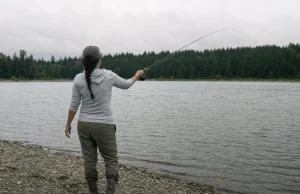 Rod Blank Feels Soft? Spot the Crack Before It Snaps Angler checking a graphite rod blank for a crack at dawn before fishing, running a thumb along the blank