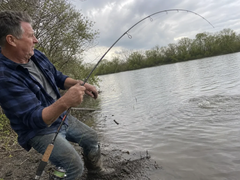 Angler fighting a fish at a safe 45 to 60 degree rod angle to avoid high-sticking a rod
