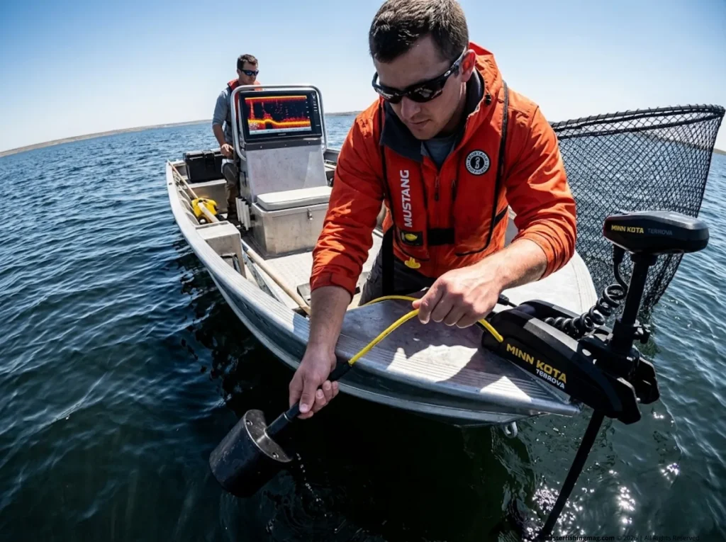 Technicians on a boat deploying acoustic herding gear.