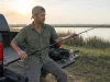 Why Telescoping Fishing Rods Snap and It’s Not the Blank Angler extending a telescoping fishing rod at a truck tailgate at first light on a travel fishing trip