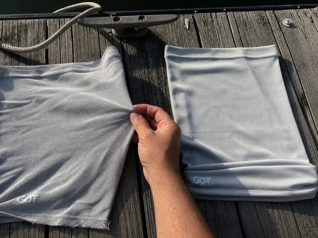 Faded and stretched fishing neck gaiter next to a new one after a full season of sun
