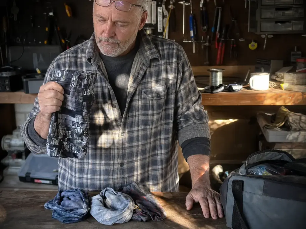 Comparing a premium and a budget fishing neck gaiter side by side before a trip