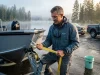 Boat Trailer Maintenance Loading Guide Field-Tested Fixes Professional angler inspecting boat trailer winch strap before launch at a misty morning ramp