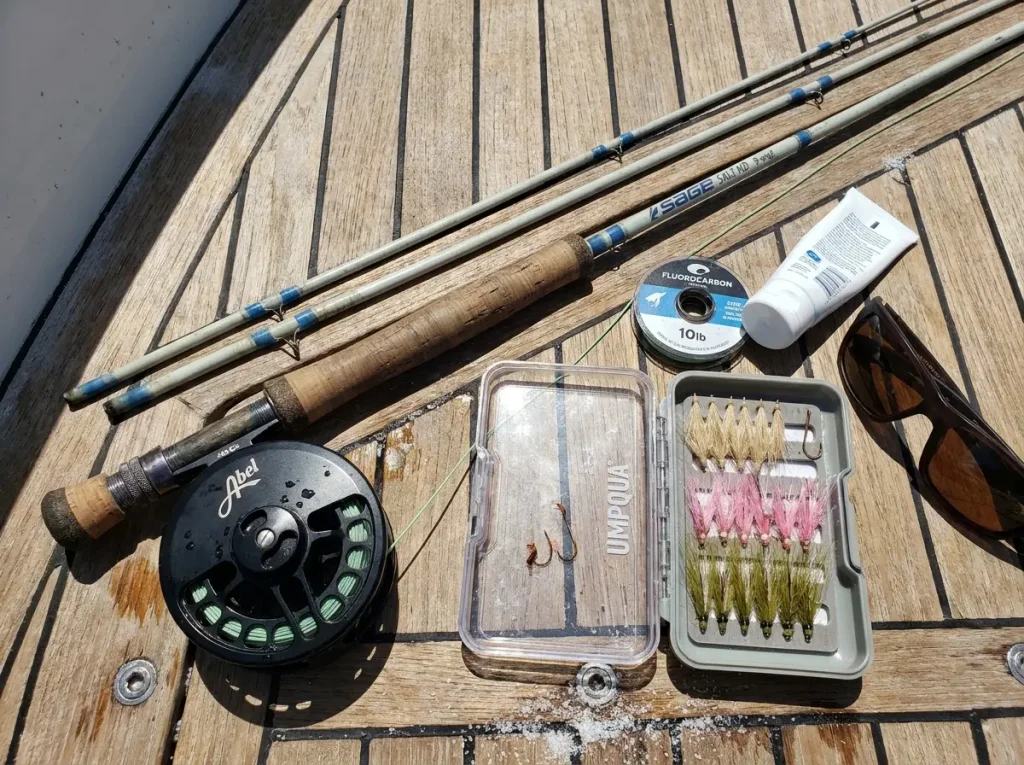Florida Keys bonefishing gear flat-lay on skiff deck with fly rod, Abel reel, and assorted bonefish flies