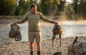 Chest Pack and Fishing Vest Tested Side by Side Angler comparing a fishing chest pack and vest on a river bank