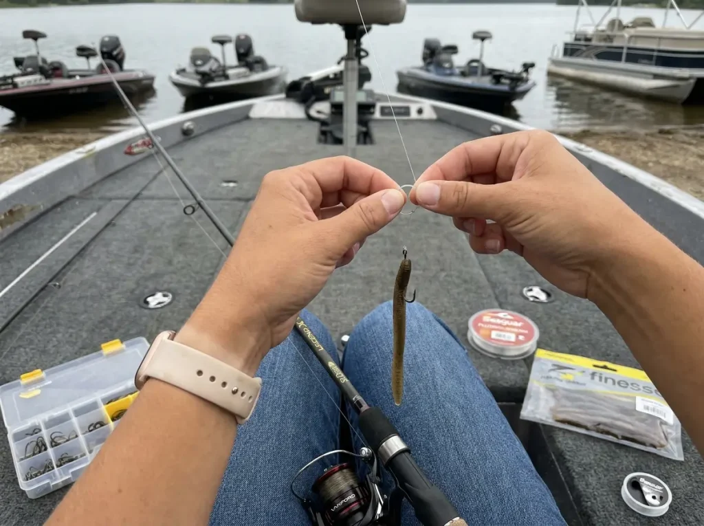 Angler rigging a finesse drop shot with light line on pressured lake