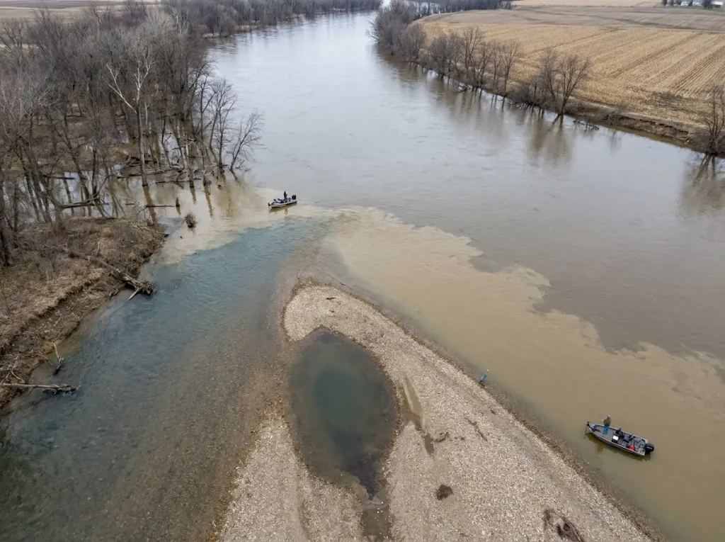 Aerial view of river tributary mouth with slack water pocket where walleye stage in spring