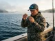 Spoon Fishing Techniques the Rapala PDF Won’t Explain Angler tying a snap practicing spoon fishing techniques casting and trolling