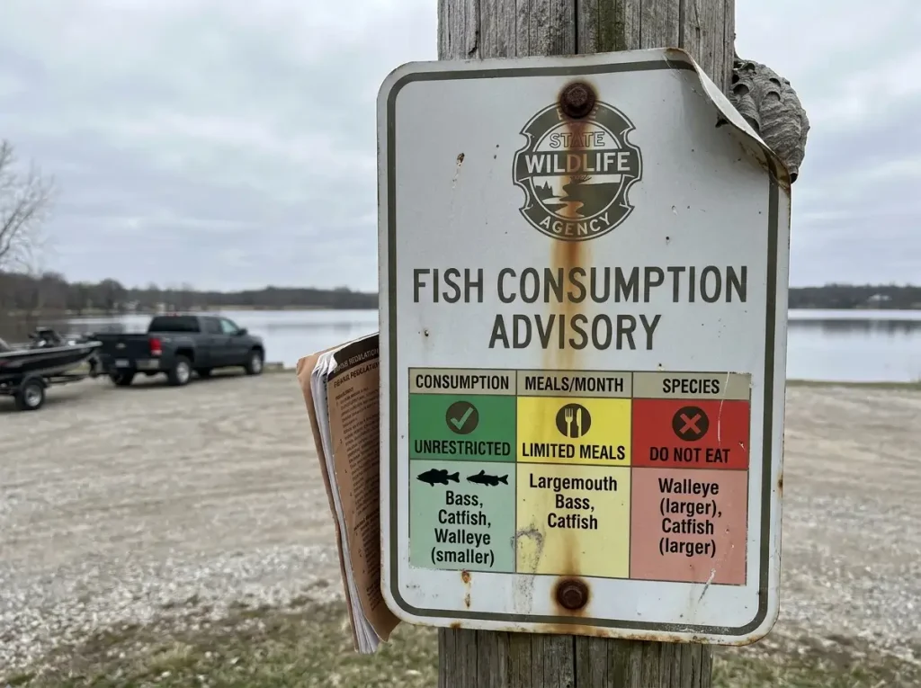 Close-up of state fish advisory sign showing species and meal limits