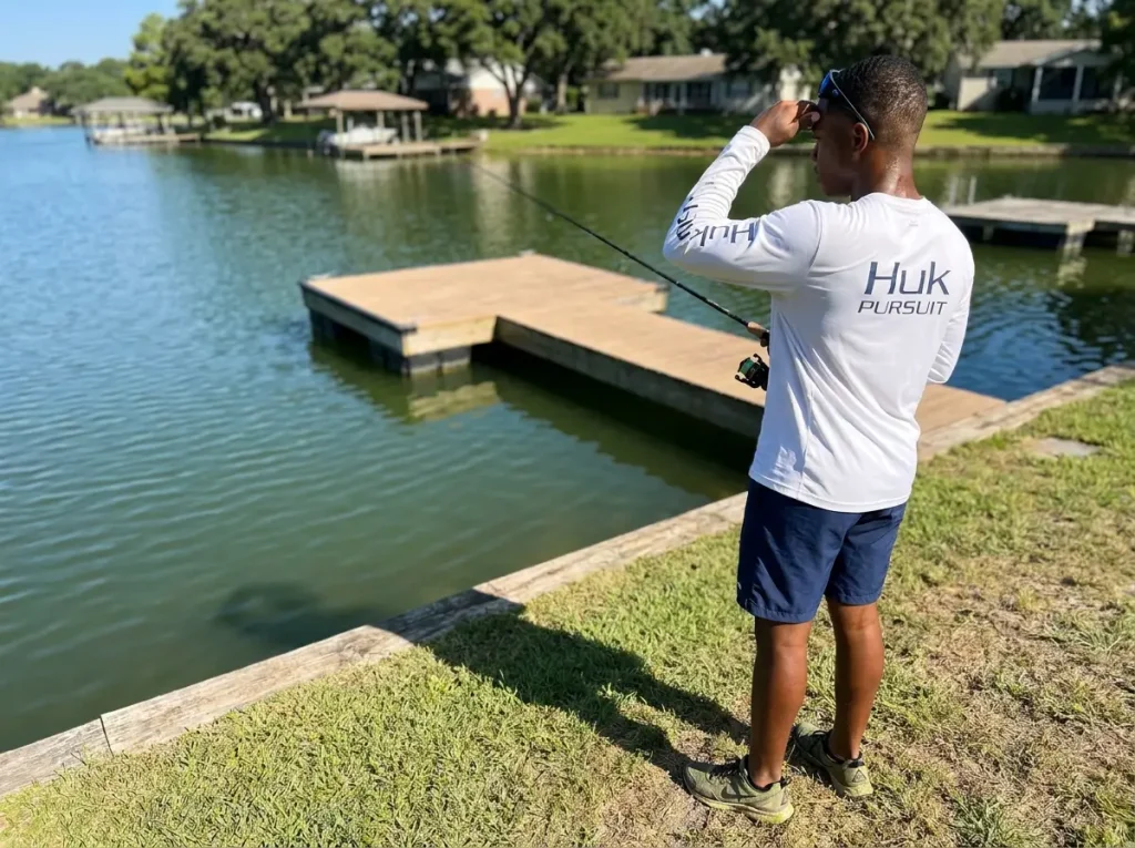 Shore angler studying shade patterns on a dock before casting