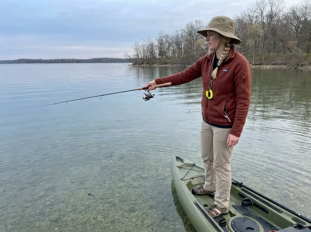Angler swimming tube jig shallow over spring gravel flat for pre-spawn smallmouth bass