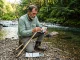 5 Water Tests That Tell You More Than Your Sonar Angler kneeling by stream holding water quality test kit with fishing rod nearby