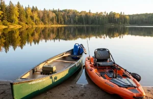 Canoe or Kayak for Fishing? The Honest Answer Canoe and fishing kayak side by side on a lake shore at sunrise