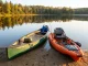 Canoe or Kayak for Fishing? The Honest Answer Canoe and fishing kayak side by side on a lake shore at sunrise