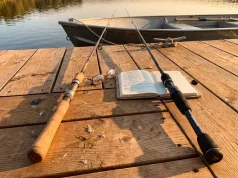 Cork vs EVA Foam Rod Handles Which Grip Wins Cork and EVA foam fishing rod handles side by side on a wooden dock