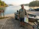 What I Do First on Every New Lake I Fish Angler studying a lake from the boat ramp on an unfamiliar body of water