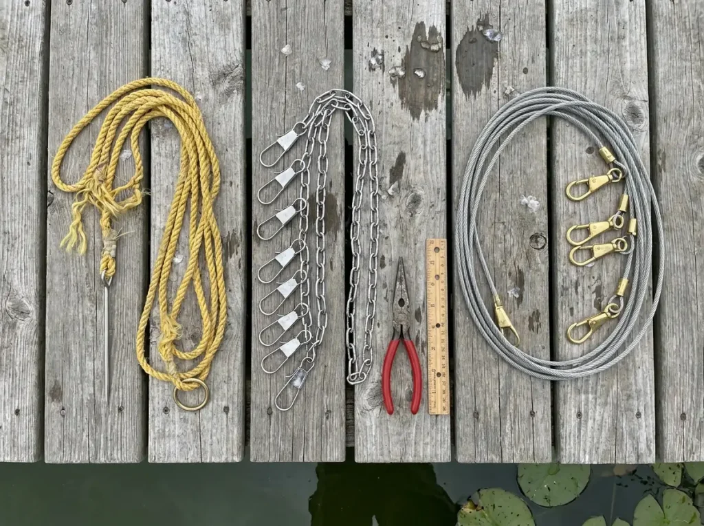 Three fish stringer types laid out on dock showing rope chain and cable styles