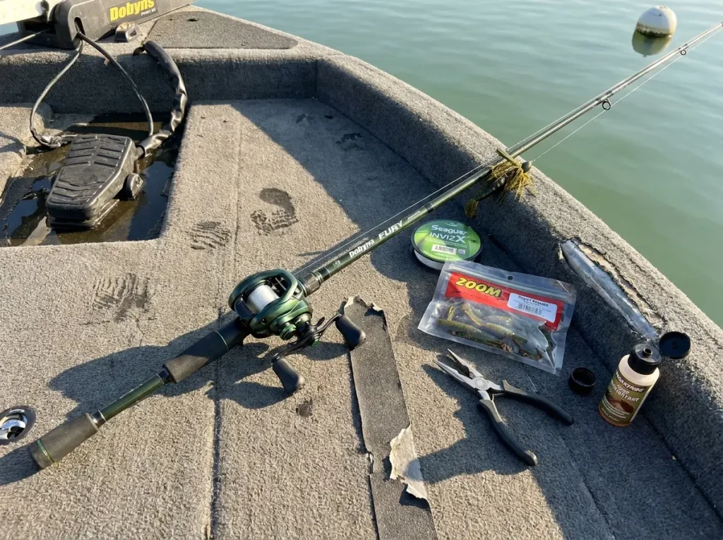 Complete football jig rod reel and line setup laid out on bass boat deck ready to fish