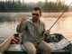 Why Most Lure Anglers Match the Hatch Wrong Angler comparing lure to live shad held in hand while reading lake surface at dawn