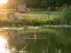 How to Fish a Slip Bobber for Panfish Step by Step Slip bobber floating on calm lake with line angled down toward panfish