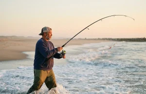 Why Most Surf Anglers Miss Striped Bass by 20 Feet surf-angler-casting-striped-bass-dawn