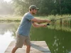 Why Your First Fishing Setup Needs Just One Combo Beginner casting a spinning rod-and-reel combo from a pond dock — a complete first fishing setup in use