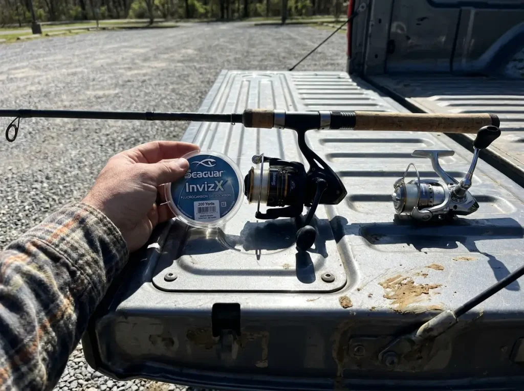 Spinning reel and rod on a tailgate with a spool of fluorocarbon line for matching line weight