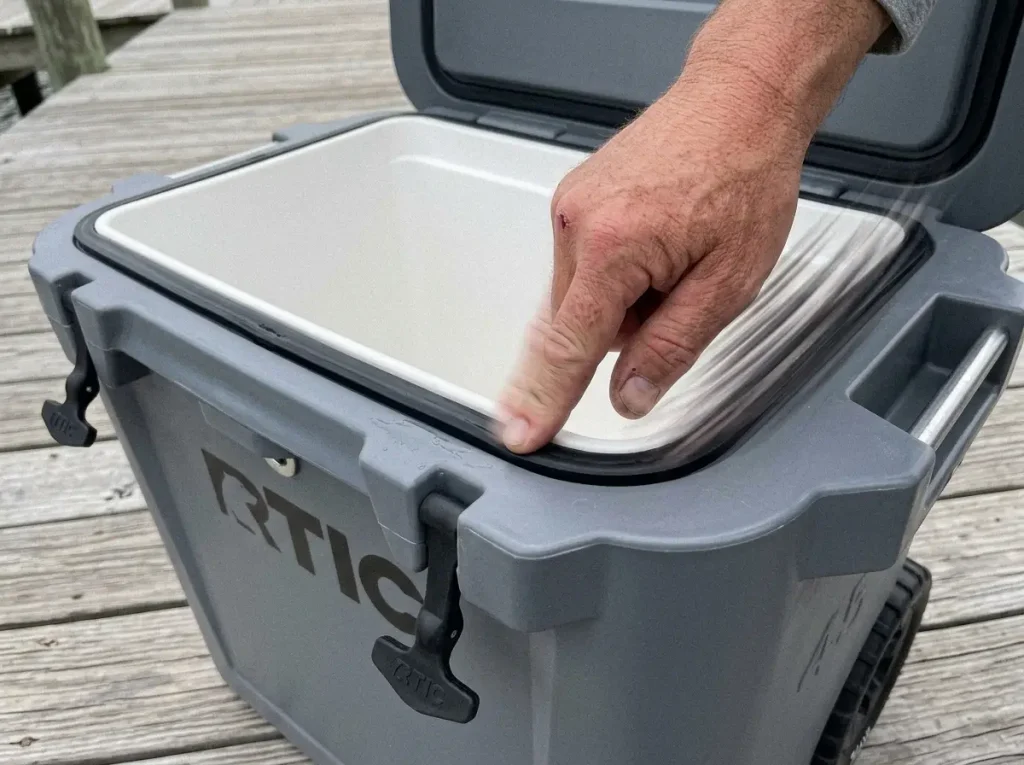 Close-up of a rotomolded fishing cooler's thick lid gasket and foam wall where ice retention comes from