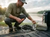 Fishing Tools and Accessories Ranked by What You Use Angler's fishing tools and accessories laid out on a boat gunwale at dawn with pliers in hand